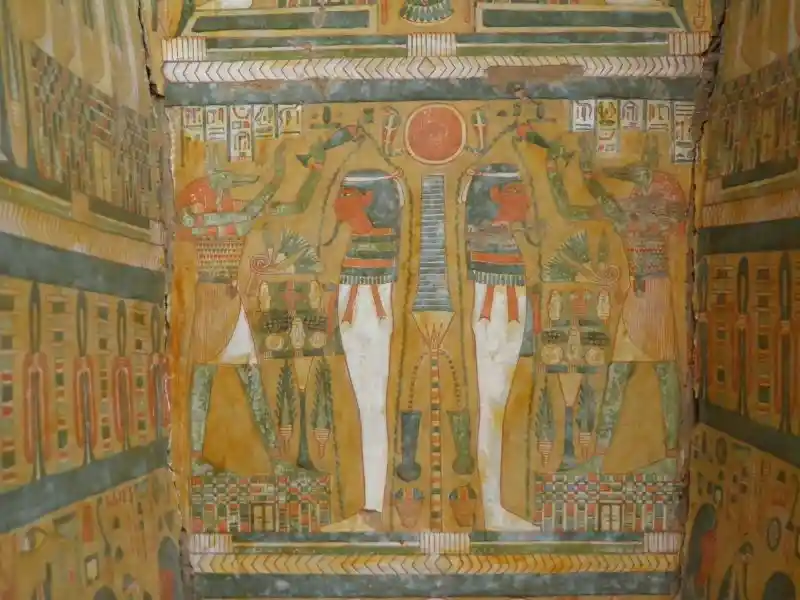 Two bearded egyptians standing with two anubis